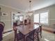 This dining room has a crystal chandelier, windows for lots of light, and access to the living room at 907 Edgewood Cir, Gastonia, NC 28052