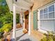 Inviting front porch featuring rocking chairs, white pillars, and a wood front door at 907 Edgewood Cir, Gastonia, NC 28052