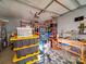Spacious garage providing ample storage with organized shelving and a functional work area at 907 Edgewood Cir, Gastonia, NC 28052