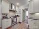 This stylish kitchen showcases stainless steel appliances, granite countertops, and white cabinetry at 907 Edgewood Cir, Gastonia, NC 28052