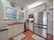 The kitchen has stainless appliances, granite counters, and white cabinets for a clean and modern look at 907 Edgewood Cir, Gastonia, NC 28052