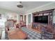 Spacious living room with hardwood floors, a large entertainment center, and views into the dining room at 907 Edgewood Cir, Gastonia, NC 28052