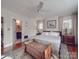 Spacious main bedroom featuring natural light, hardwood floors, and a view to the bathroom at 907 Edgewood Cir, Gastonia, NC 28052