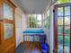 Charming sunroom with a built-in bench seat, bright windows, and access to the outdoors at 907 Edgewood Cir, Gastonia, NC 28052