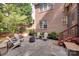 Backyard patio with stone pavers, fire pit, and outdoor seating area at 9217 Tenby Ln, Matthews, NC 28104