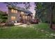 Expansive backyard with a patio, deck, and lush greenery at 9217 Tenby Ln, Matthews, NC 28104