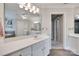 Spacious bathroom with double vanity, large mirror, and adjacent tub/shower at 9217 Tenby Ln, Matthews, NC 28104