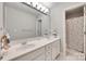 Well-lit bathroom featuring double sinks, and a shower with a patterned shower curtain at 9217 Tenby Ln, Matthews, NC 28104