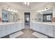 Spacious bathroom featuring double vanities and a separate glass-enclosed shower and tub at 9217 Tenby Ln, Matthews, NC 28104