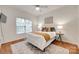 Bright bedroom features hardwood floors, a ceiling fan, and natural light at 9217 Tenby Ln, Matthews, NC 28104