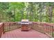Wooden deck with grill and railing overlooking a wooded area at 9217 Tenby Ln, Matthews, NC 28104