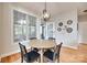 The dining room features a round table, a decorative chandelier, and natural light at 9217 Tenby Ln, Matthews, NC 28104