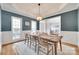 Dining room with wainscoting, a modern light fixture, and views of the foyer and office at 9217 Tenby Ln, Matthews, NC 28104
