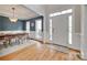 Bright entryway featuring hardwood floors, a stylish rug, and a dining room with navy blue walls at 9217 Tenby Ln, Matthews, NC 28104