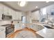 Bright kitchen features white cabinets, stainless steel appliances, and quartz countertops at 9217 Tenby Ln, Matthews, NC 28104