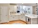 The kitchen features white cabinets, stainless steel appliances, and an eat-in bar at 9217 Tenby Ln, Matthews, NC 28104