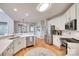 The kitchen features white cabinets, stainless steel appliances, and an eat-in bar at 9217 Tenby Ln, Matthews, NC 28104