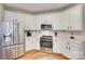 Bright kitchen features white cabinets, stainless steel appliances, and quartz countertops at 9217 Tenby Ln, Matthews, NC 28104