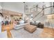 Open-concept living room with hardwood floors, a staircase, and a view of the kitchen at 9217 Tenby Ln, Matthews, NC 28104