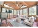 Comfortable screened porch with wood ceiling, ceiling fan, and cozy seating area at 9217 Tenby Ln, Matthews, NC 28104