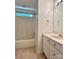 Bright bathroom featuring a tub/shower with a white vanity and neutral tile flooring at 9907 Furlong Trl, Charlotte, NC 28269