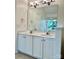 Bathroom featuring a double sink vanity, large mirror, and neutral paint at 9907 Furlong Trl, Charlotte, NC 28269