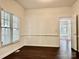 Dining room featuring wood floors and white chair rail with a window and door at 9907 Furlong Trl, Charlotte, NC 28269