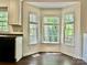 Eat-in kitchen with wood floors, wainscotting and bay window with view of the yard at 9907 Furlong Trl, Charlotte, NC 28269