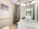 Bathroom featuring a glass shower, marble countertop, and neutral color palette at 100 N Laurel Ave # 107, Charlotte, NC 28207