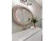 Bathroom with white marble countertop and oversized oval mirror with soft lighting above vanity at 100 N Laurel Ave # 107, Charlotte, NC 28207