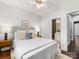 Bedroom featuring a queen-size bed, ceiling fan, and ensuite bathroom at 100 N Laurel Ave # 107, Charlotte, NC 28207