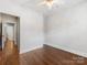 A serene bedroom showcasing hardwood floors, neutral walls and an entrance to the hallway at 100 N Laurel Ave # 107, Charlotte, NC 28207