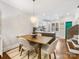 Open dining room showcasing stylish chandelier, hardwood floors, and easy access to the kitchen at 100 N Laurel Ave # 107, Charlotte, NC 28207