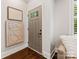 Neutral door, wood floors, and a stylish artwork enhance this entryway's appeal at 100 N Laurel Ave # 107, Charlotte, NC 28207