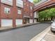 Charming brick condo building featuring attached garages and connecting bridge, ideal for city living at 100 N Laurel Ave # 107, Charlotte, NC 28207