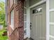 Close-up of a stylish front door with sidelights, complementing the classic brick exterior of the home at 100 N Laurel Ave # 107, Charlotte, NC 28207