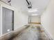 Spacious two car garage featuring a standard roll up garage door, and an entrance door at 100 N Laurel Ave # 107, Charlotte, NC 28207