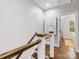 Hallway with hardwood floors, light gray walls, white trim, and modern art on the wall at 100 N Laurel Ave # 107, Charlotte, NC 28207