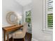 Cozy home office featuring a desk, chair, mirror, and natural light at 100 N Laurel Ave # 107, Charlotte, NC 28207