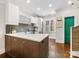 Modern kitchen with large island, stainless steel appliances, and stylish backsplash at 100 N Laurel Ave # 107, Charlotte, NC 28207