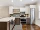 Bright kitchen with stainless steel appliances, modern cabinetry, and breakfast bar at 100 N Laurel Ave # 107, Charlotte, NC 28207