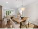 Open concept living space featuring hardwood floors, modern lighting, and a view to the seating area at 100 N Laurel Ave # 107, Charlotte, NC 28207