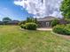 A manicured backyard features lush greenery and mature trees, complemented by a well-maintained patio at 1021 Mallard Landing Dr, Monroe, NC 28110