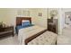 Cozy bedroom featuring a wooden bed frame, tufted ottoman, and neutral decor at 1021 Mallard Landing Dr, Monroe, NC 28110