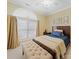 Bright bedroom with a large arched window, wooden bed, and tufted bench at 1021 Mallard Landing Dr, Monroe, NC 28110