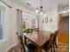 Inviting dining room features natural light and a classic chandelier over a wood table at 1021 Mallard Landing Dr, Monroe, NC 28110