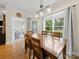 Bright dining area features a wooden table with seating for six and a view to the backyard at 1021 Mallard Landing Dr, Monroe, NC 28110