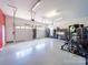 Spacious three car garage featuring overhead lighting, storage and workout equipment at 1021 Mallard Landing Dr, Monroe, NC 28110