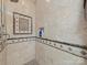 Shower features tile surround with a built-in niche and a mosaic tile accent at 1021 Mallard Landing Dr, Monroe, NC 28110