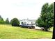 Charming single story home on a large lot featuring a lush green lawn and mature trees and a truck in the driveway at 103 Amy Dr, Kings Mountain, NC 28086